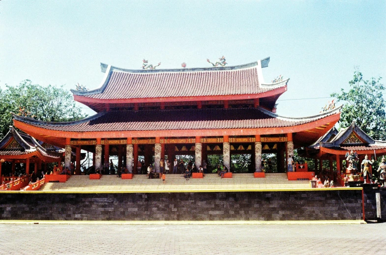 a group of people standing in front of a building, a colorized photo, inspired by Gong Xian, holy place, jakarta, orange roof, exterior view