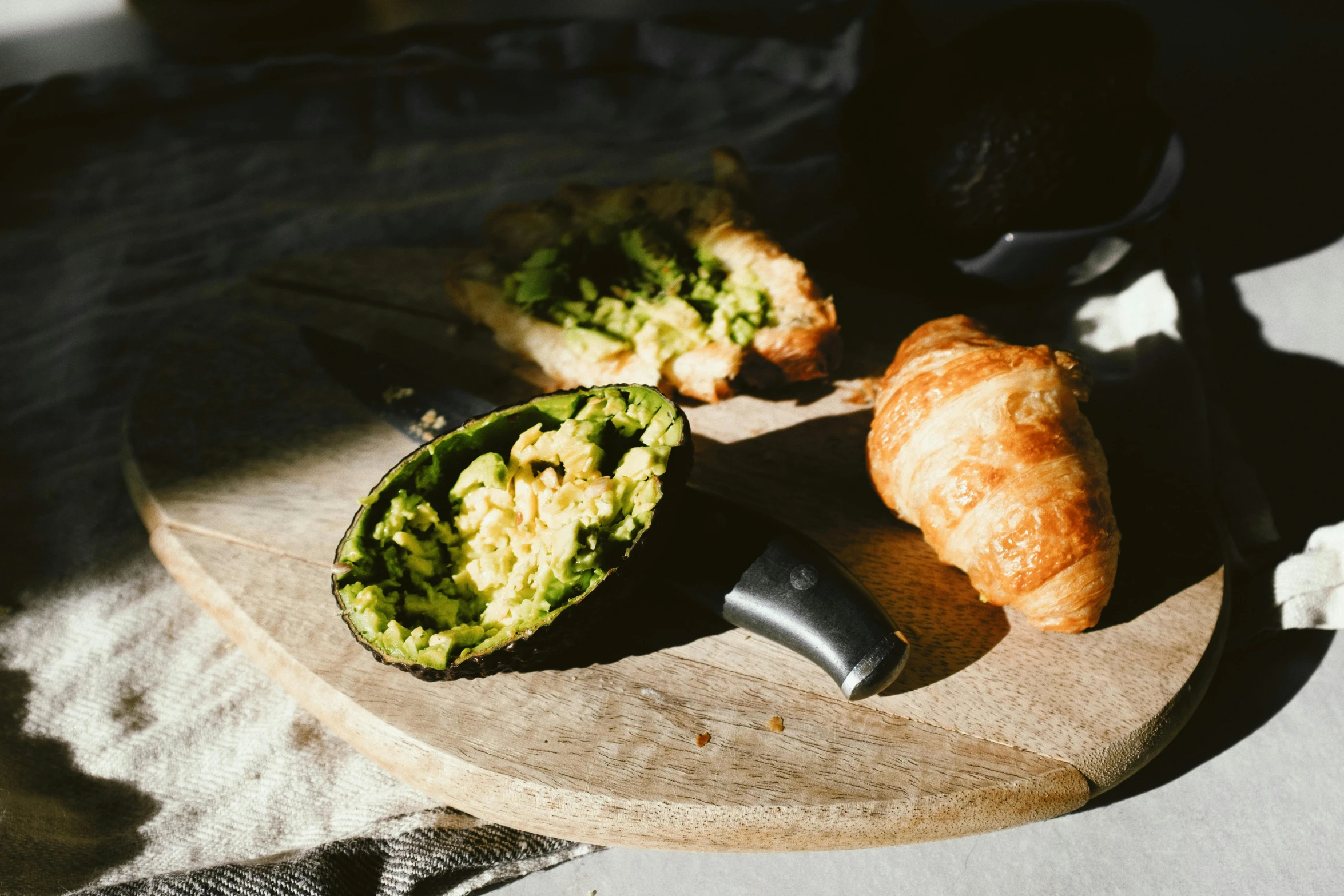 a close up of a plate of food on a table, a still life, unsplash, private press, avocado and cheddar, baking french baguette, black and green, picnic