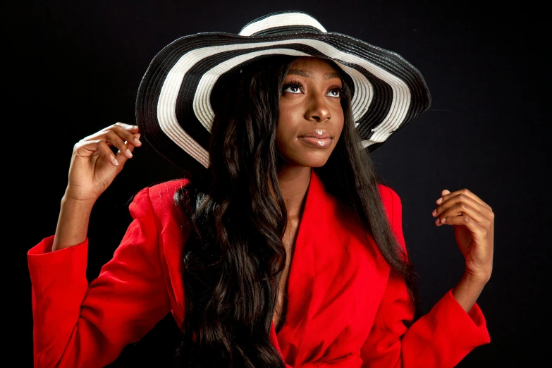 a woman in a red shirt and a black and white hat, an album cover, by Lily Delissa Joseph, posing elegantly, portrait n - 9, vanessa blue, high quality image