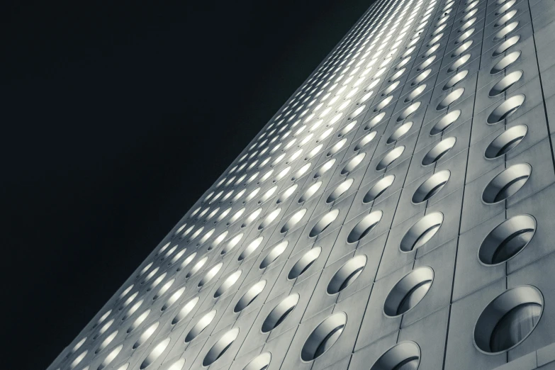 a black and white photo of a tall building, by Matthias Weischer, unsplash contest winner, light and space, made of dots, glowing windows, hyperdetailed photograph, square lines