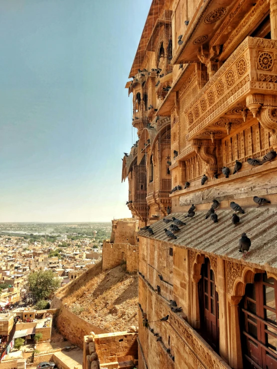 a view of a city from the top of a hill, a detailed matte painting, pexels contest winner, renaissance, painting of mehrangarh fort, bird\'s eye view, shades of gold display naturally, intricate carved wood