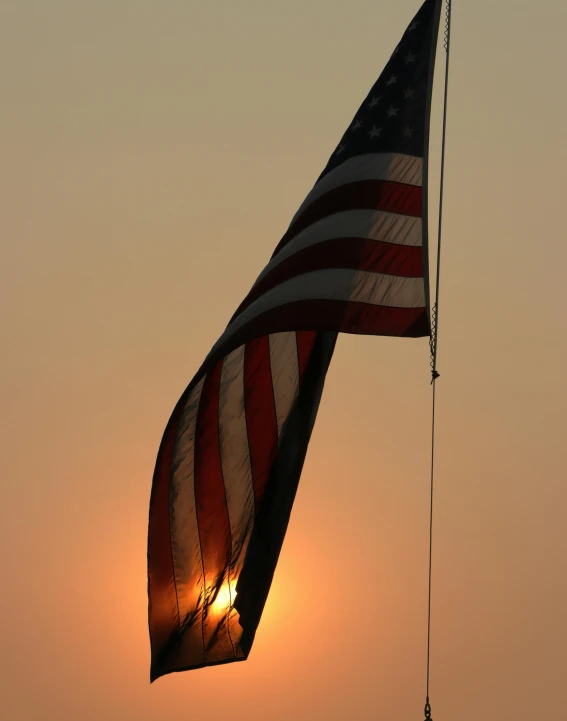 an american flag blowing in the wind at sunset, by Alison Geissler, slide show, lgbt, burned, sails