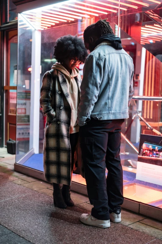 a man and a woman standing in front of a store, happening, cold lighting, facing each other, chillin at the club together, street wears