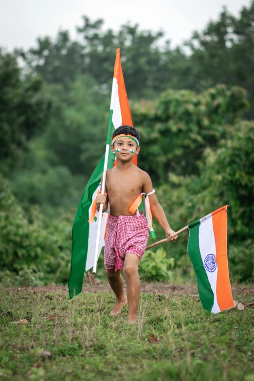 a boy holding an indian flag in a field, an album cover, pexels contest winner, celebration costume, parade, wearing authentic attire, profile image