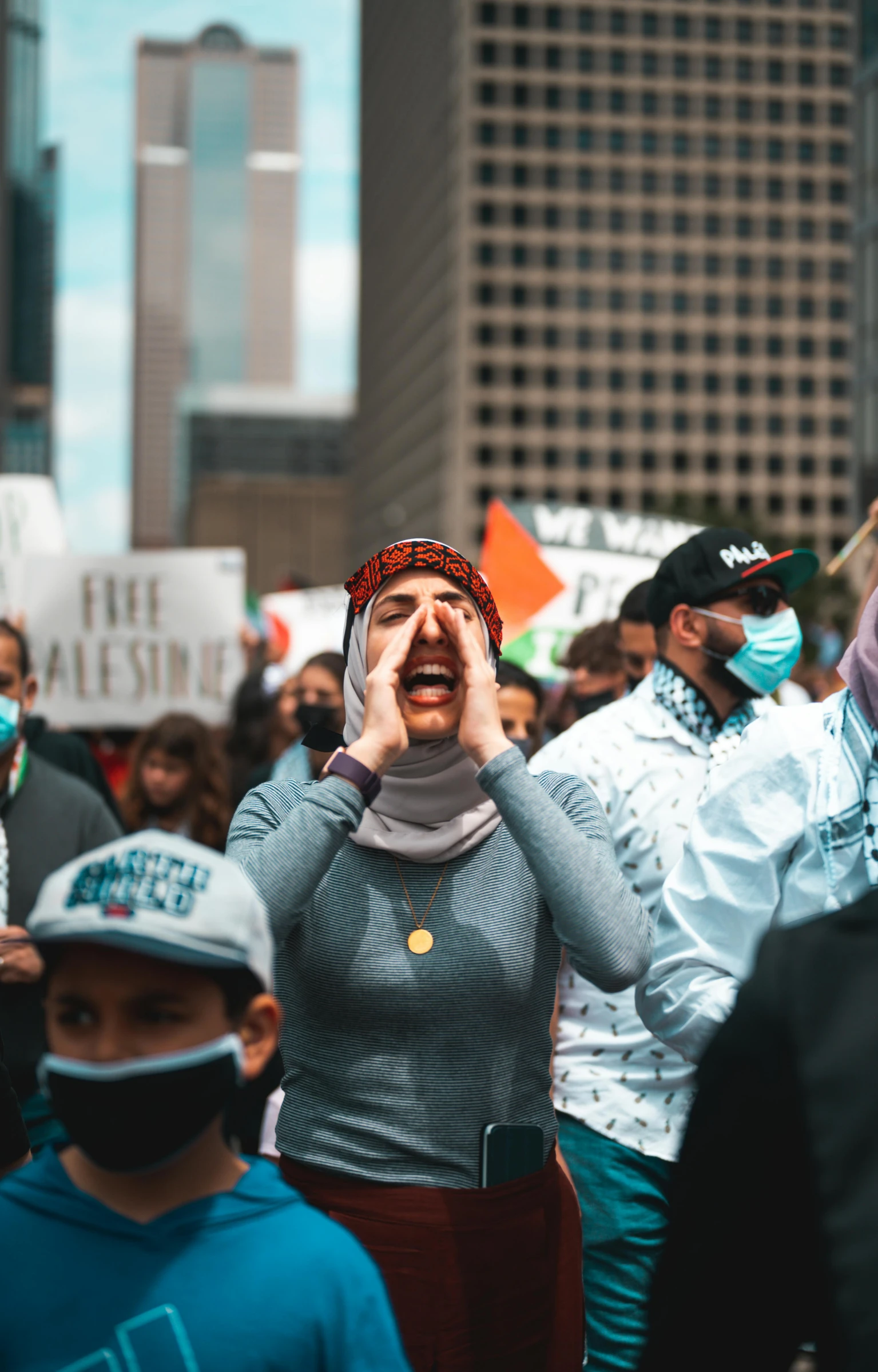 a group of people that are standing in the street, pexels, protest, woman crying, face covered, toronto