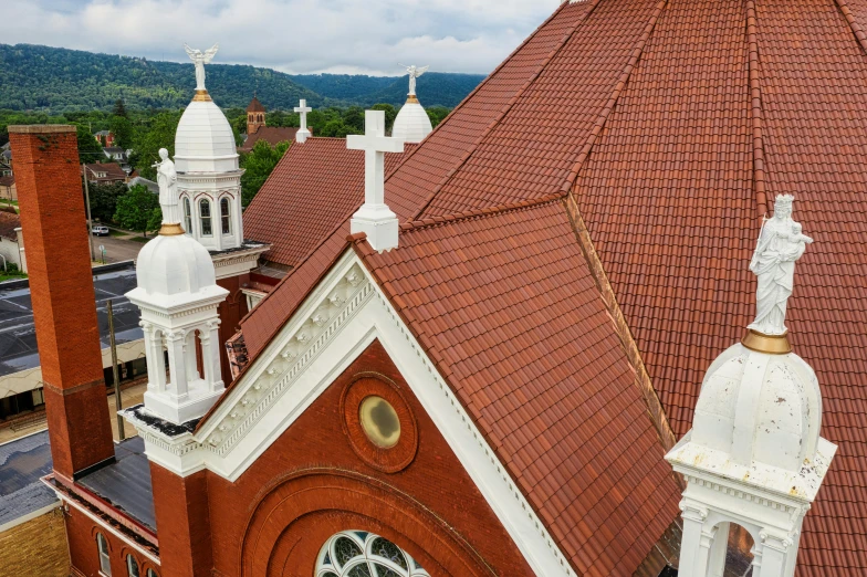 an aerial view of a church with a clock tower, galvalume metal roofing, looking over west virginia, stained glass windows, profile image