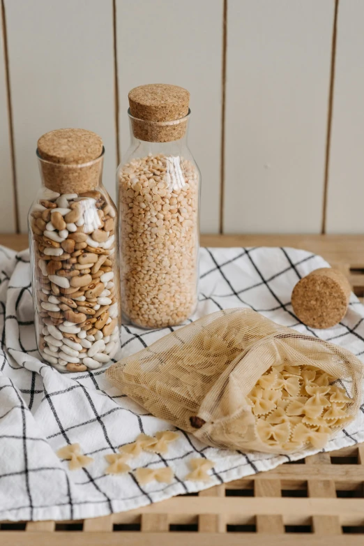 a bunch of food sitting on top of a wooden table, a picture, jars, detailed product image, cereal, detail shot
