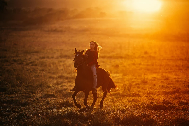 a woman riding on the back of a brown horse, by Emma Andijewska, unsplash contest winner, golden hour 8k, rectangle, sun lighting, jen bartel