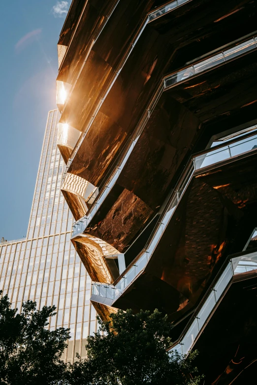 a very tall building with a lot of windows, inspired by Zaha Hadid, unsplash contest winner, draped in shiny gold and silver, golden hour in manhattan, honeycomb halls, close - up profile