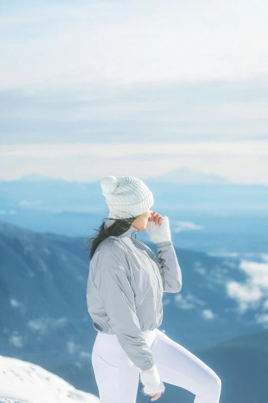 a woman standing on top of a snow covered mountain, profile image, whistler, looking off into the distance, scenic view