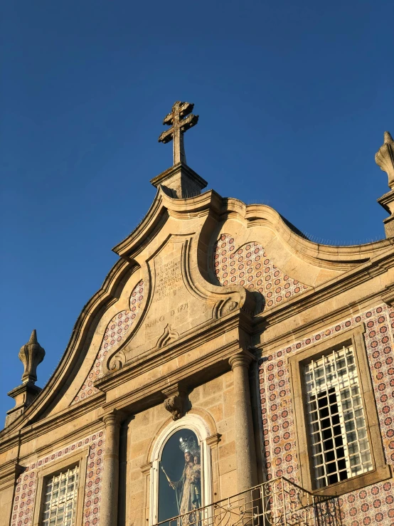 a large building with a clock on top of it, romanesque, azulejo, profile image, ribbon chapel, during golden hour