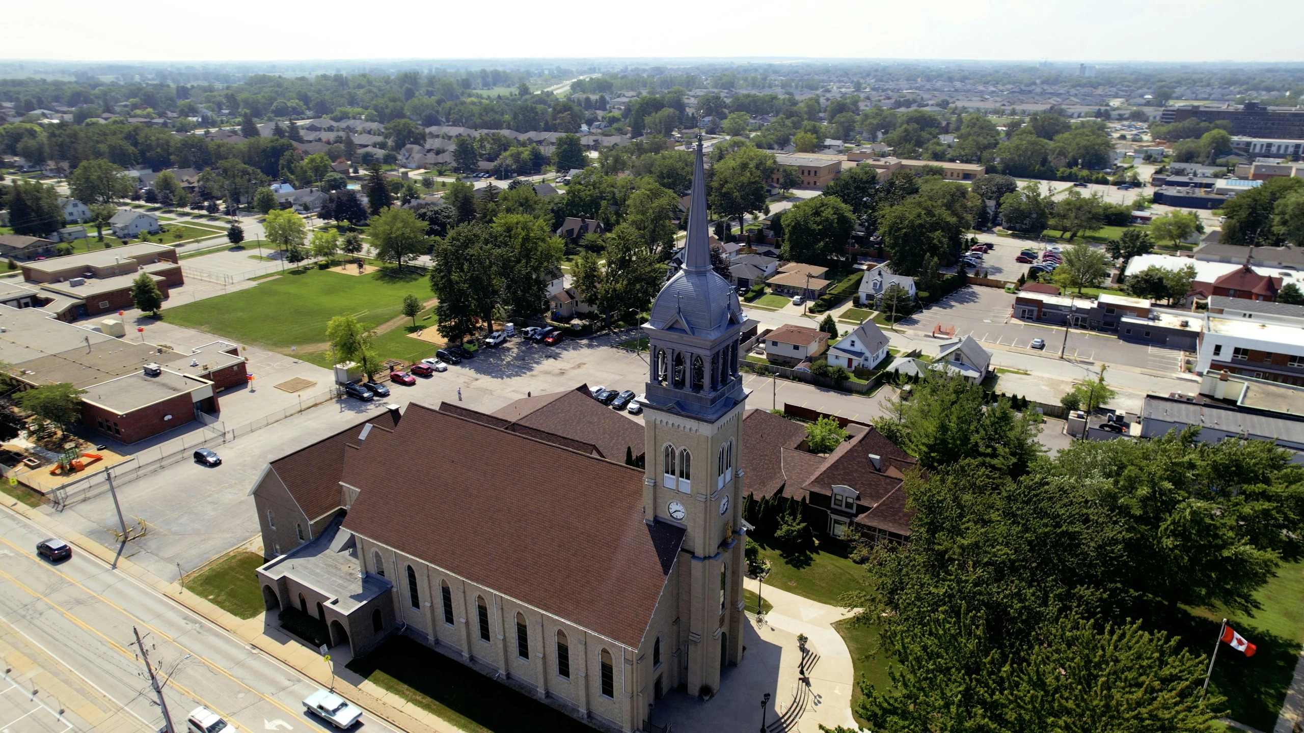 an aerial view of a church with a clock tower, by Joe Stefanelli, 8 k -, wideshot, carson ellis, gray