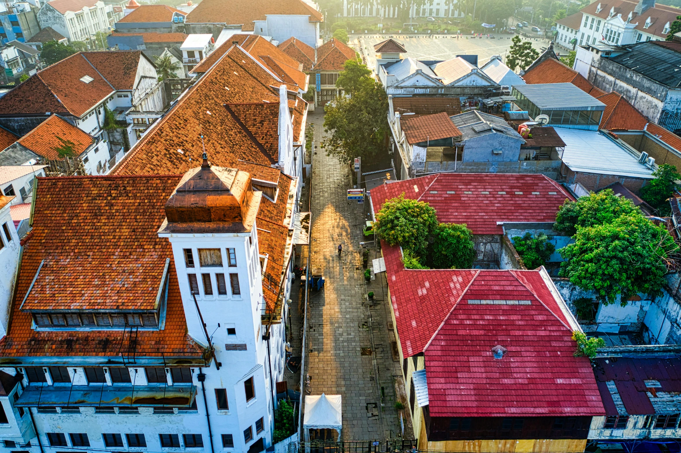 a view of a city from a bird's eye view, inspired by Erik Pevernagie, pexels contest winner, colonial era street, indonesia, background image, square