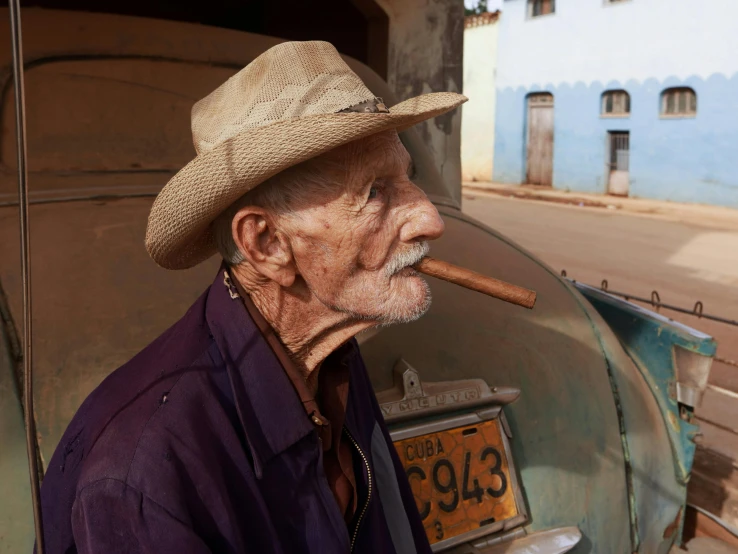an old man wearing a hat smoking a cigar, pexels contest winner, hyperrealism, joel meyerowitz, cuban revolution, square, ap news photograph