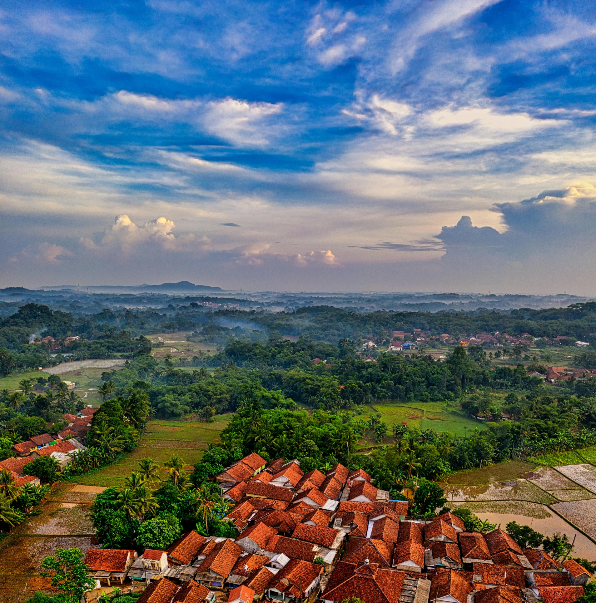 a view of a village from the top of a hill, by Basuki Abdullah, pexels contest winner, square, wide angle shot 4 k hdr, big sky, malaysian