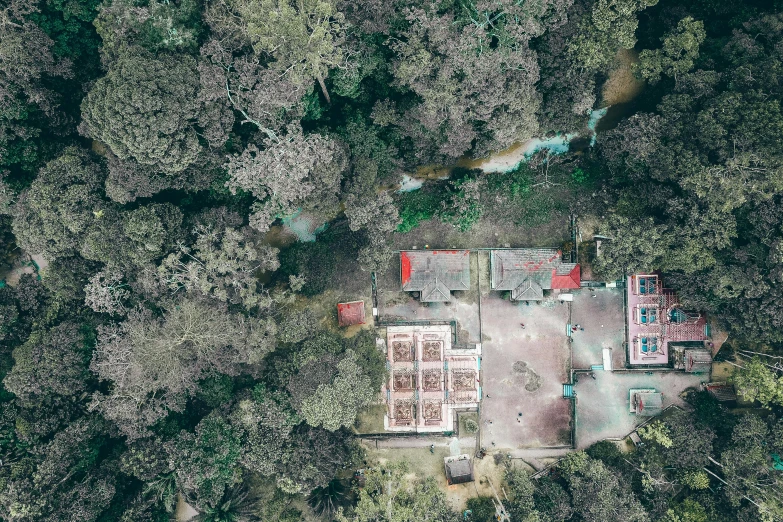 an aerial view of a house in the middle of a forest, an album cover, unsplash, quito school, military buildings, assam tea garden background, photogrammetry, 🦑 design