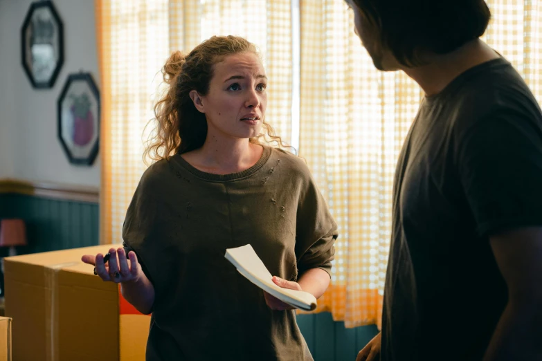 a woman standing next to a man in a living room, happening, dialogue, straya, production still, school class