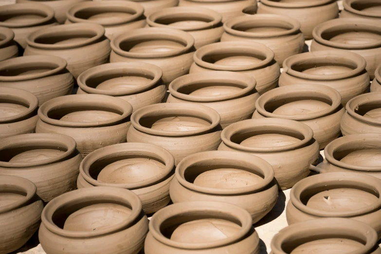 a group of clay pots sitting on top of a table, inspired by Ai Weiwei, trending on unsplash, mingei, thumbnail, complex pattern, brown, professionally post-processed