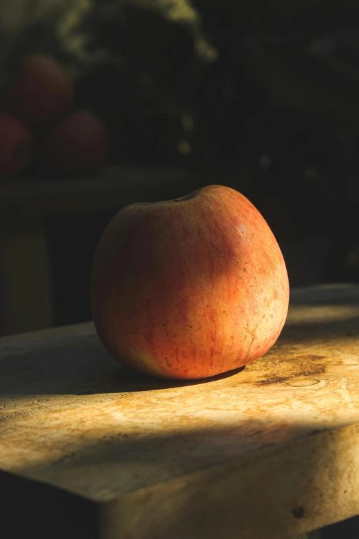 an apple sitting on top of a wooden cutting board, inspired by Elsa Bleda, pexels, renaissance, back light, an alien fruit, slide show, looking left