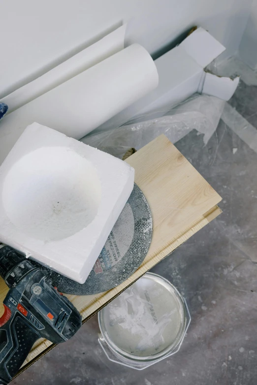 a white toilet sitting next to a pile of toilet paper, a marble sculpture, tools, epoxy resin, on a wooden plate, profile image