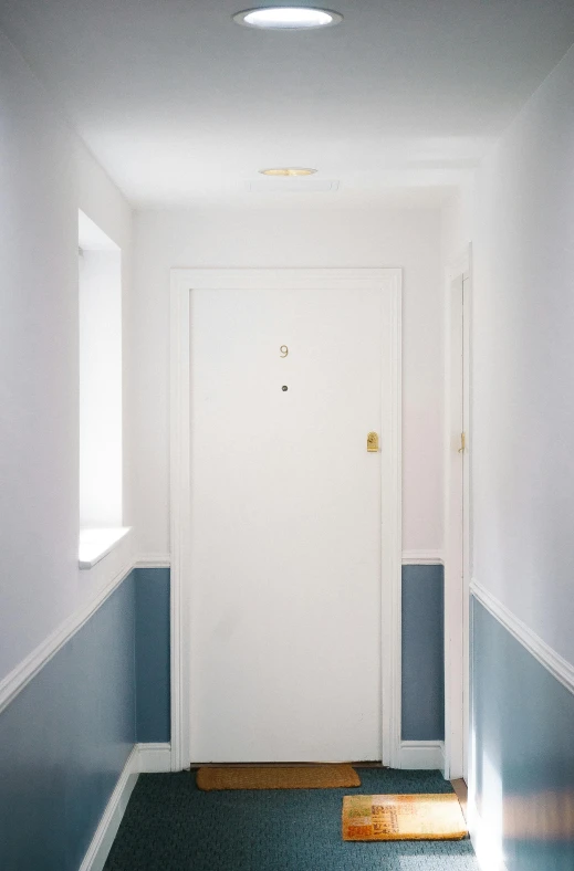 a hallway with blue walls and a white door, by Doug Ohlson, postminimalism, recessed, no - text no - logo, zinc white, whitespace