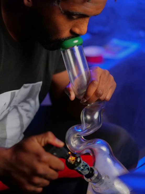 a man that is sitting down with a pipe, glassware, up close, led gaming, swirly tubes