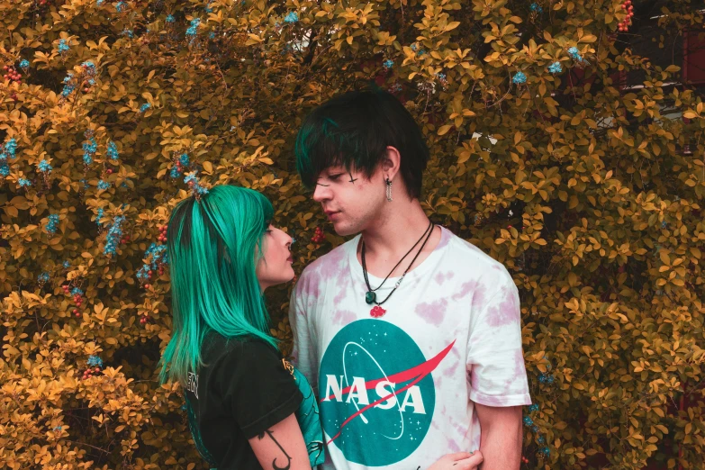 a man and a woman standing next to each other, inspired by Elsa Bleda, pexels contest winner, green hair, girl in space, cute emo guy, nasa image