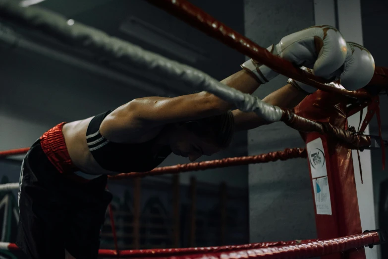 a close up of a person in a boxing ring, a digital rendering, pexels contest winner, unreal engine cinematic, women fighting men, head down, local gym