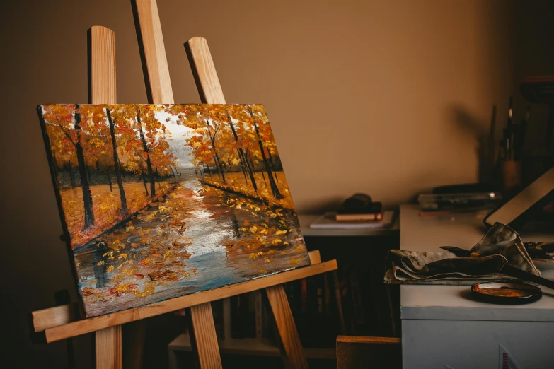 a painting sitting on top of a wooden easel, inspired by Peter Fiore, pexels contest winner, during autumn, in an art gallery], afremov leonid, canvas