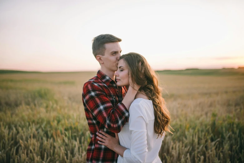 a man and woman standing in a field at sunset, pexels contest winner, attractive girl, profile image, making out, high quality product image”