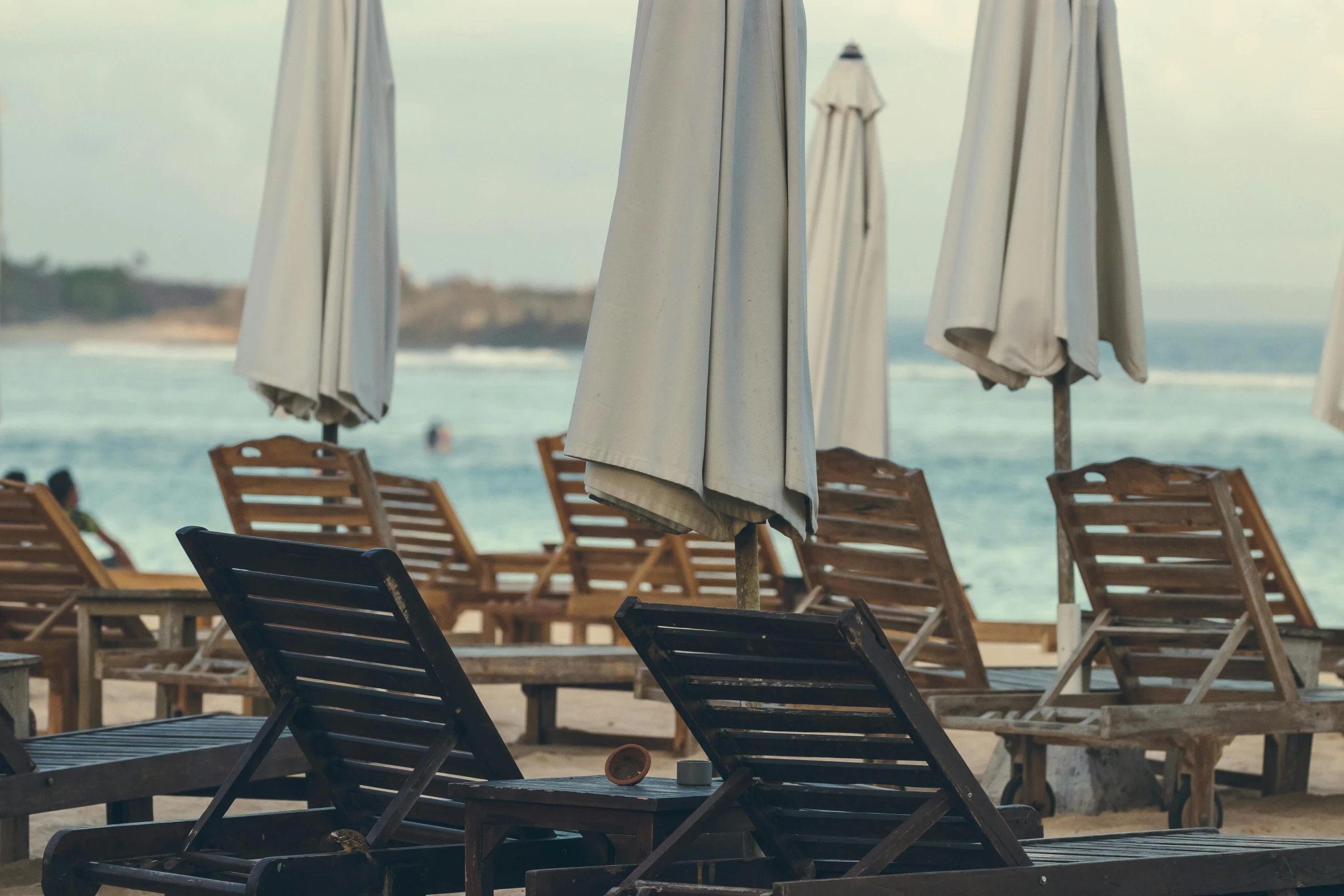 lounge chairs and umbrellas on a beach with the ocean in the background, pexels contest winner, renaissance, thumbnail, brown, panels, [ cinematic