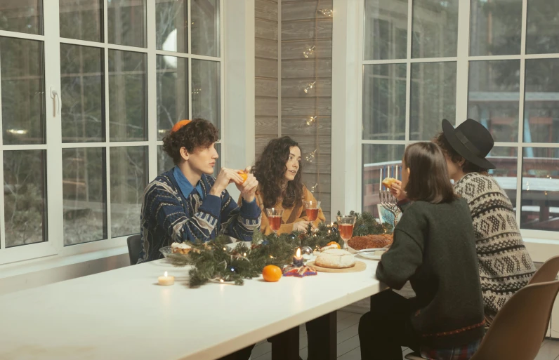 a group of people sitting around a white table, holiday season, finn wolfhard, shot on sony a 7, abcdefghijklmnopqrstuvwxyz