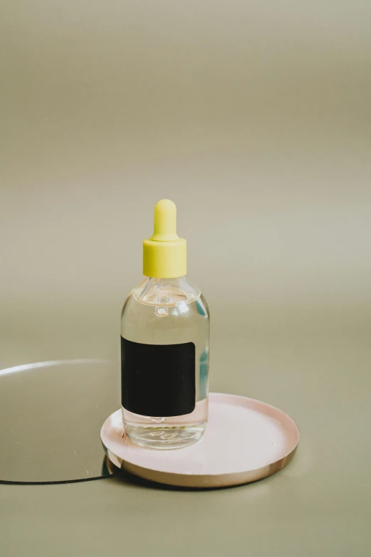 a bottle of liquid sitting on top of a plate, by Winona Nelson, acne, slide show, vapor, banana