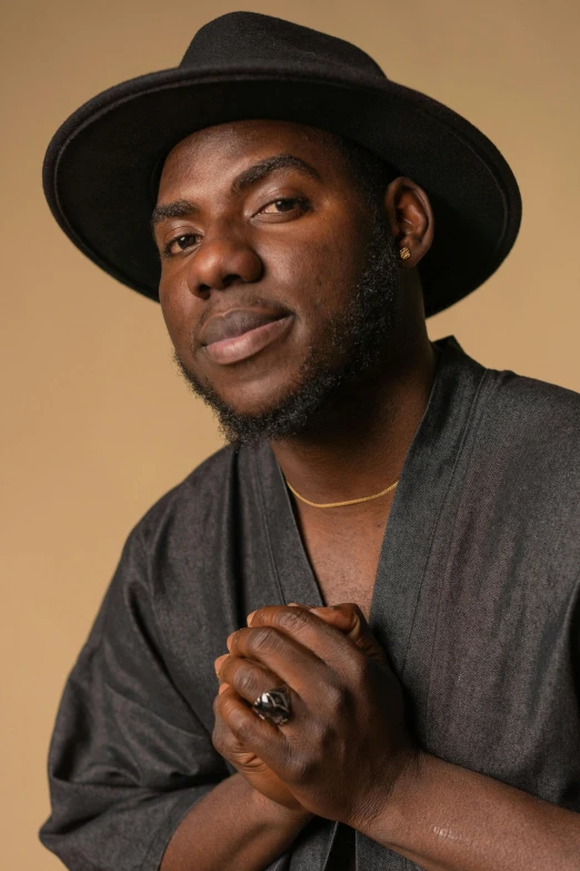 a close up of a person wearing a hat, inspired by Theo Constanté, trending on pexels, black arts movement, actor, confident pose, baptiste from overwatch, mid length portrait photograph