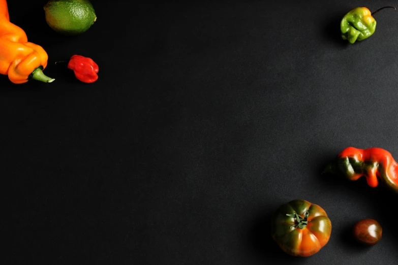 a black table topped with assorted fruits and vegetables, by Andries Stock, pexels contest winner, minimalist rule of thirds, tomato, background image, black main color