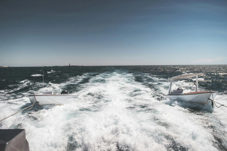 a couple of boats that are in the water, by Adam Marczyński, pexels contest winner, happening, ocean spray, back towards camera, panoramic shot, heavy lines