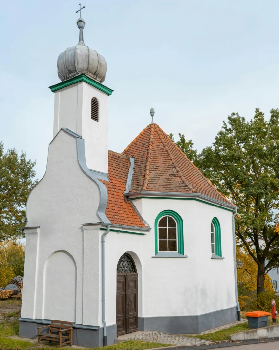 a small white church sitting on the side of a road, by Heinrich Bichler, unsplash, art nouveau, lucas cranach, portrait image