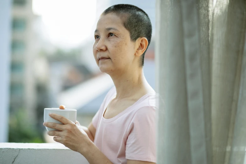 a woman standing on a balcony holding a cup, a portrait, inspired by Cui Bai, pexels contest winner, brown buzzcut, 4 5 yo, thoughtful ), asian human