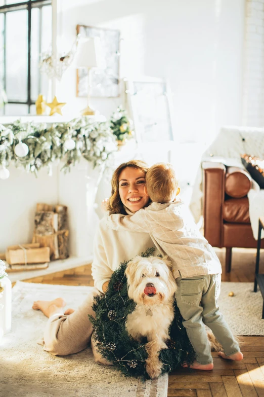 a woman sitting on the floor with a dog, decorations, with a kid, profile image, cozy setting