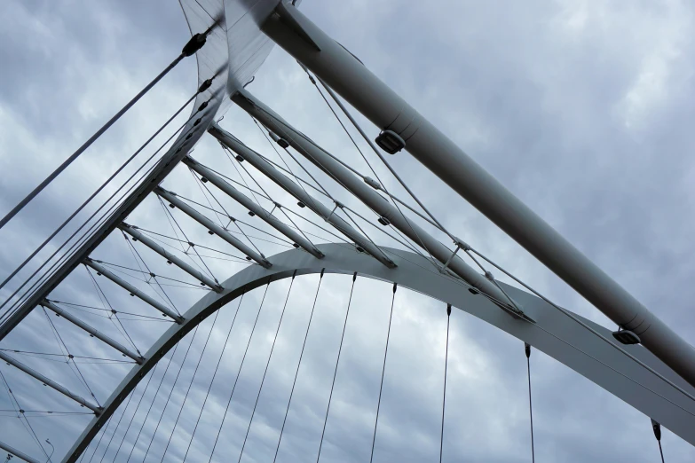 the underside of a bridge against a cloudy sky, inspired by Richard Wilson, unsplash, constructivism, white sweeping arches, thin wires, glasgow, ultrafine detail ”