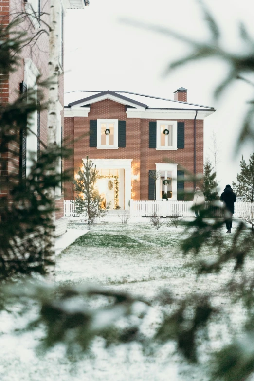 a person walking in the snow in front of a house, holiday vibe, profile image