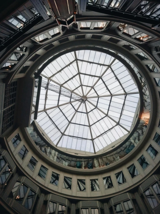 the inside of a building with a glass roof, everything enclosed in a circle, photo on iphone, shot on sony a 7, mall