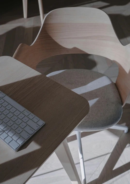 a laptop computer sitting on top of a wooden desk, by Carey Morris, unsplash, computer art, froggy chair, subtle pattern, ignant, chairs