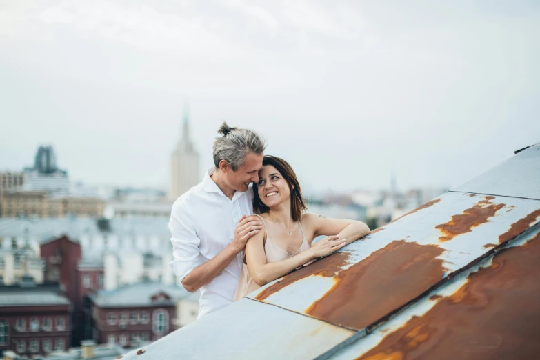 a man and woman standing on top of a roof, a photo, by Jakob Gauermann, pexels contest winner, romanticism, smiling couple, white, 15081959 21121991 01012000 4k, ukrainian