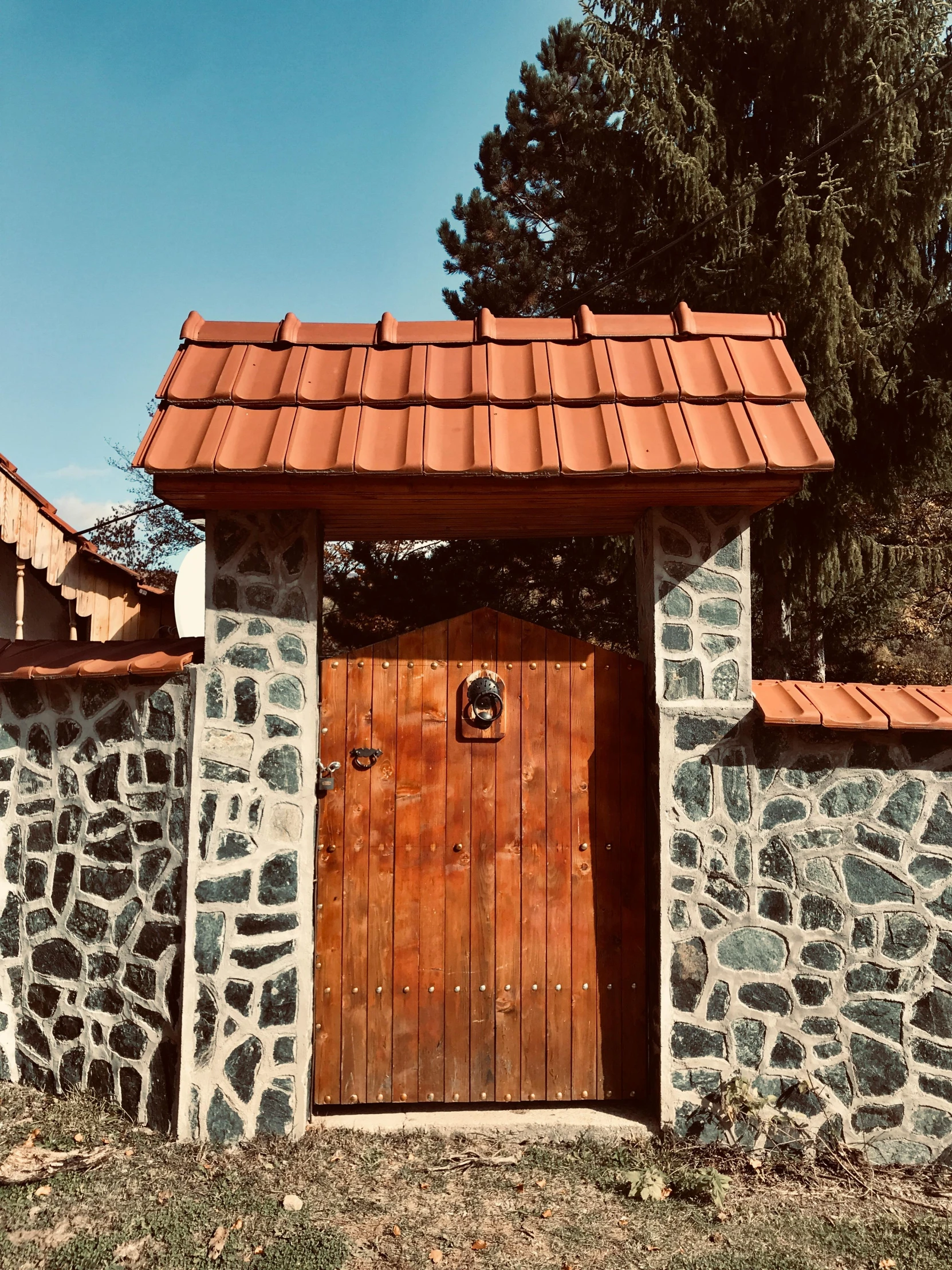 a stone building with a wooden door in front of it, 8k))