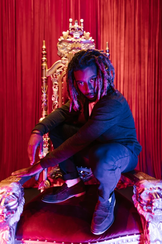a man with dreadlocks sitting on a throne, red lighting, poofy, official store photo, ye mighty