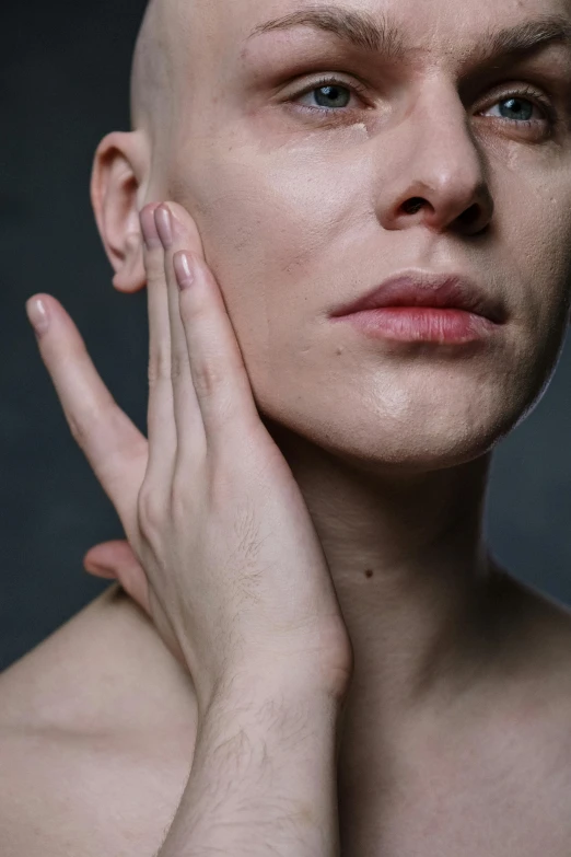 a close up of a person with a bald head, pexels, hyperrealism, hand on her chin, skincare, square masculine jaw, albino skin