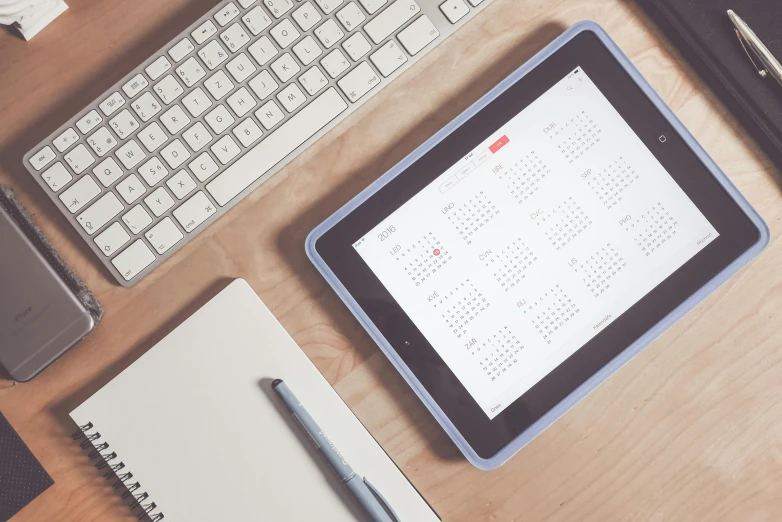 a tablet computer sitting on top of a wooden desk, by Carey Morris, trending on unsplash, female calendar, square, student, 15081959 21121991 01012000 4k