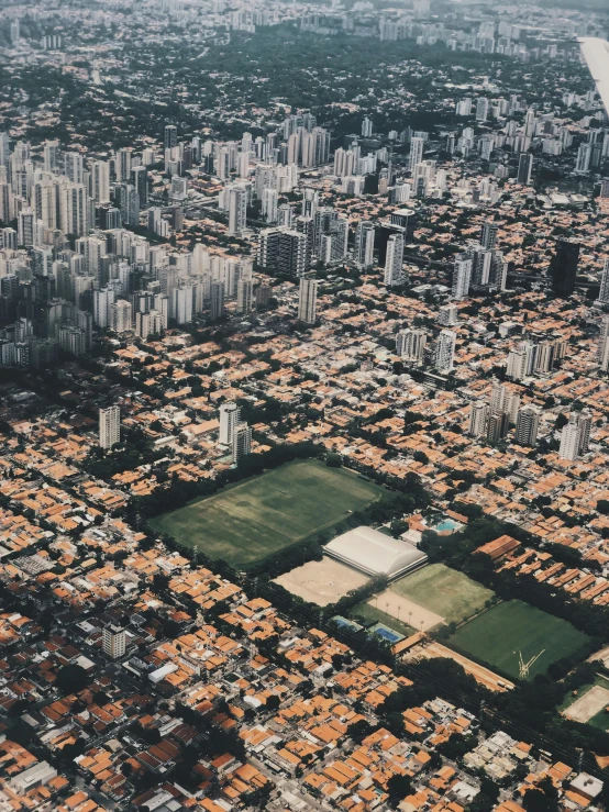 an aerial view of a city with lots of tall buildings, an album cover, by Matteo Pérez, pexels contest winner, brazilian, suburbs, sport, 15081959 21121991 01012000 4k