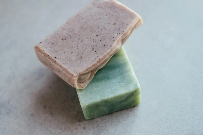 three soap bars stacked on top of each other, by Emma Andijewska, green and pink, pale as marble, mid shot, male and female